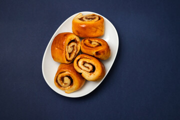 small cinnamon buns on a white dish