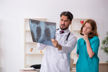 Young male doctor radiologist and female assistant working in th