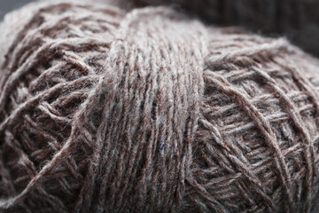 Balls of brown wool yarn made of natural wool.