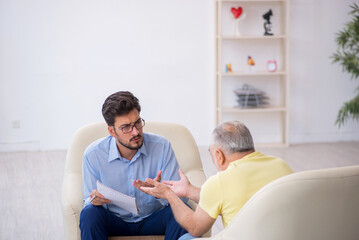 Old man visiting young male psychotherapist