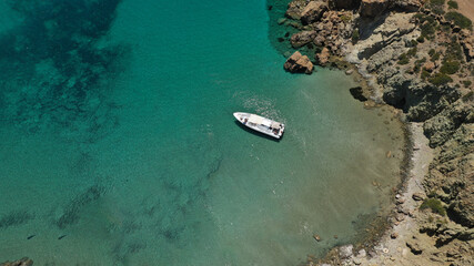 Aerial drone photo of inflatable rib boat anchored in beautiful beach of Kalogria with emerald crystal clear sea, Milos island, Cyclades, Greece