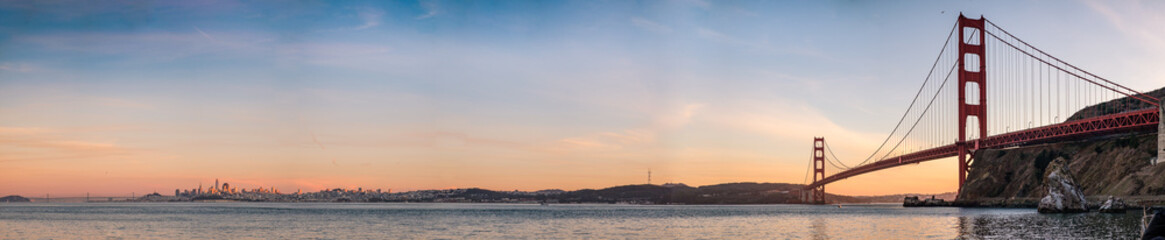Fototapeta na wymiar A panoramic view of San Francisco skyline at dusk, with colorful clouds and the bay