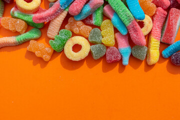Fizzy candy against an orange background
