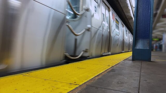 Subway station in New York. Train departure, passengers riding.