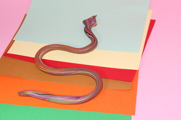 colorful snake on colorful background playing with plasticine children's fun