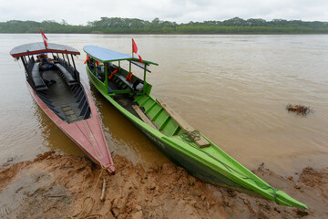 Wooden boats on the shore of a river in the Amazon jungle