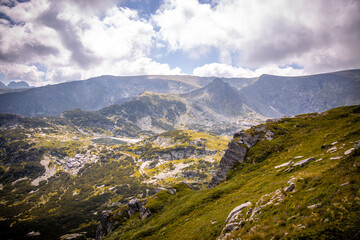 Bulgarian landscape of a mountain peak in Rila mountain.Beautiful nature landscape.Green grass and blue sky with clouds. High quality photo
