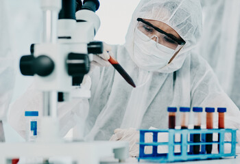 Fototapeta premium The answers are in the details. Shot of a scientist in hazmat suit conducting medical research in a laboratory.