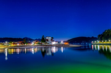 Fototapeta premium Entrance to the port of Ribadesella, with Santa Marina beach in the background, on a starry night.