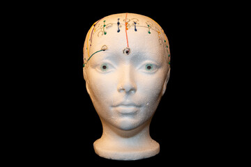 Acupuncture study of the front of the head with black background