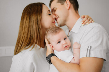 a happy family with a newborn baby at home. mom, dad and baby.