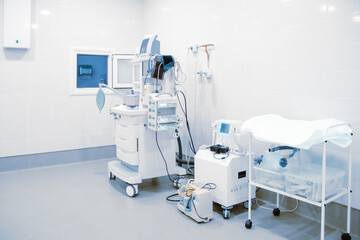 Empty interior operating room and modern equipment in hospital. Medical device for surgeon surgical emergency patient in blue tone style. Save life medical treatment concept