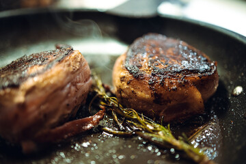 Medallion steak cooking on stove