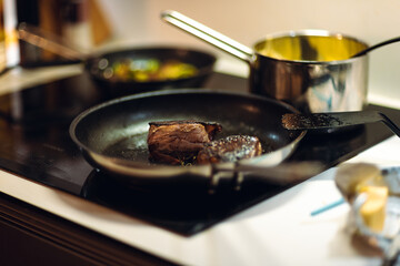 Medallion steak cooking on stove