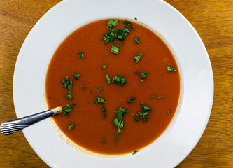 bowl of tomato soup with parsley
