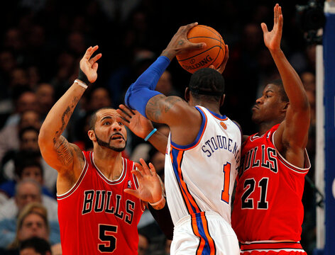 Knicks Stoudemire is defended by Bulls Boozer and Butler during their NBA basketball game at Madison Square Garden in New York