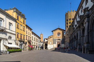 View of the square “Piazza della Repubblica” in Orvieto historic center with the church of S. Andrea and the town hall, Umbria, Italy