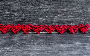layout in the form of red hearts on a wooden background