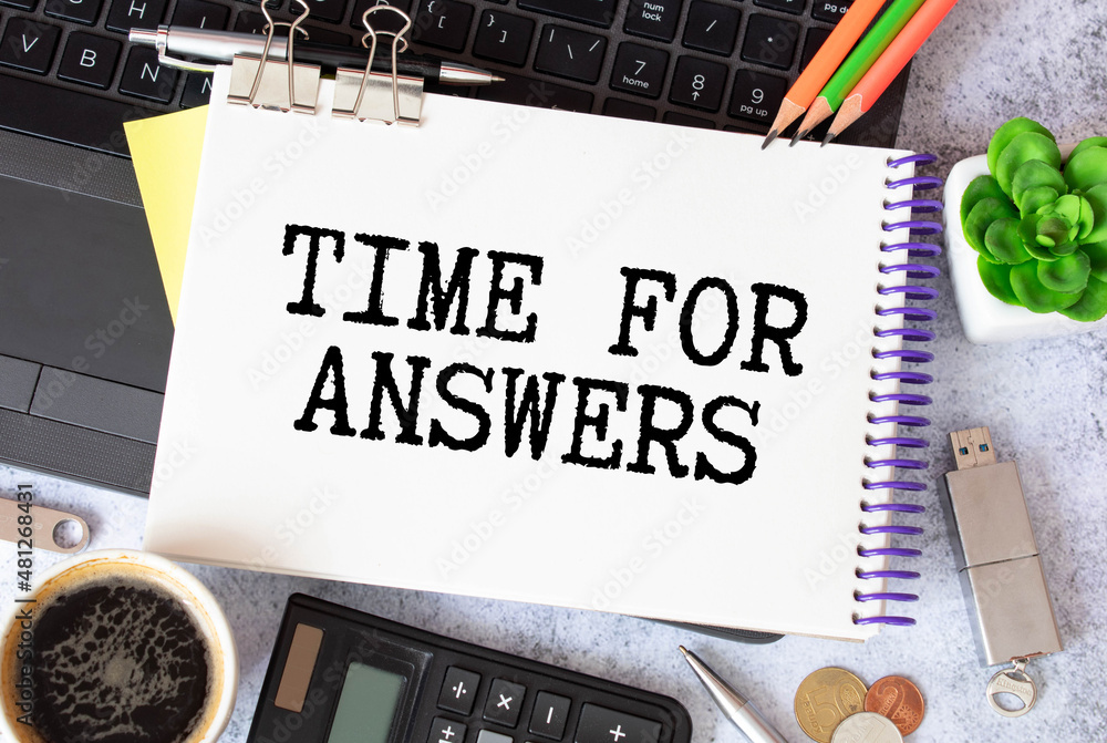 Poster on a pink background, pen and notebook with the text time for answers