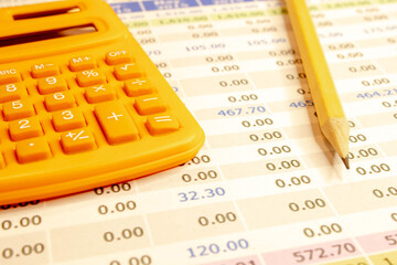 Orange calculator on a bright blue paper background. Office supplies. Education. back to school.