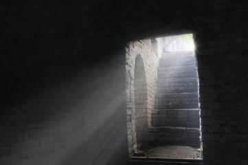 Old gloomy dungeon lightened by sun rays - freedom concept