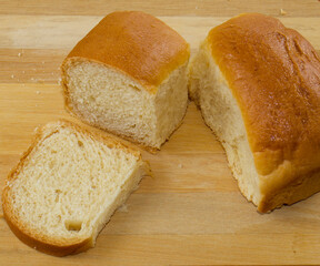 Delicious homemade and saudish bread and wooden background in selective focus and macro photo.
