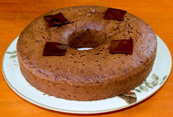 Delicious chocolate cake and wooden background in selective focus and macro photo.