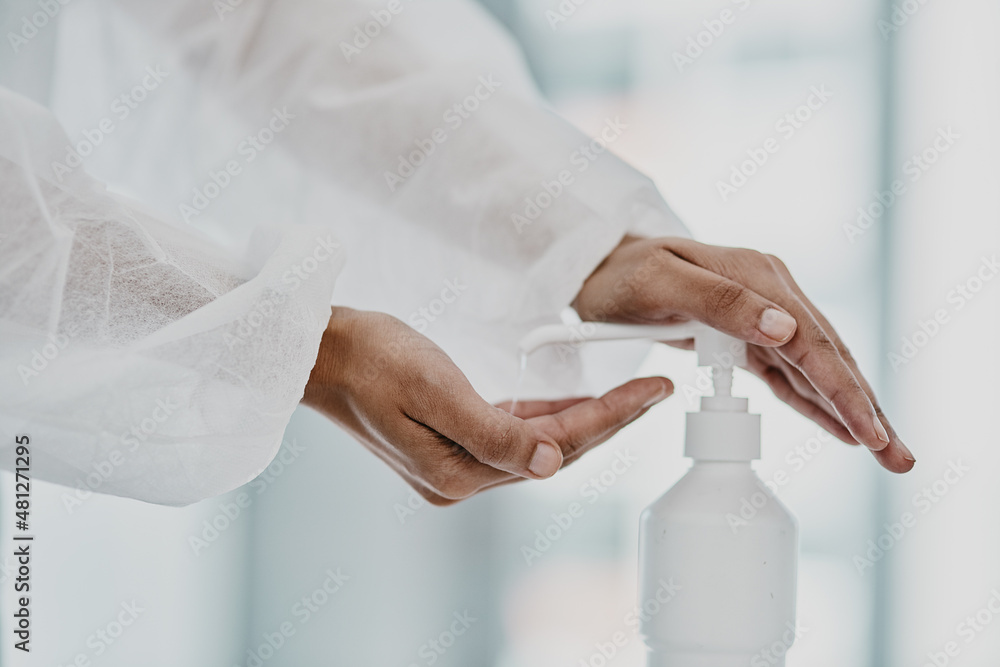 Sticker Stay sanitised, stay safe. Cropped shot of a healthcare worker disinfecting herself with hand sanitiser.