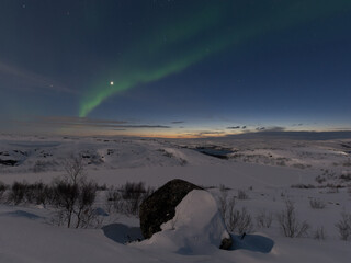 Beautiful aurora borealis in the tundra in winter.