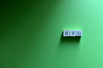 The white cubes are lined up with the letters "ESG". It is an acronym for Environmental, Social and Governance. Copy space is available.