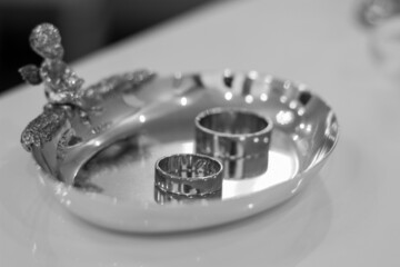 rings for the bride and groom. wedding day. solemn day. black and white photo.