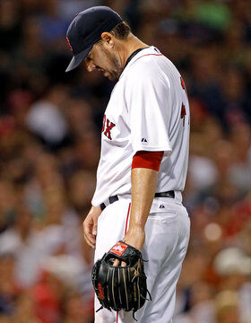 Boston Red Sox's Lackey reacts after giving up a two-run home run to Cleveland Indians' Cabrera during their MLB American League baseball game in Boston