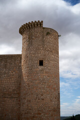  Vertical shot of the tower of Castle against a cloudy sky