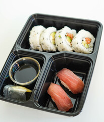 Tray with assorted pieces of sushi. California roll.