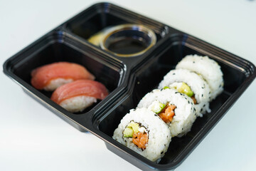 Tray with assorted pieces of sushi. California roll.