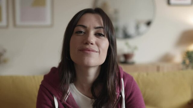 4K video screen of young adult woman listening during a video call chat using laptop webcam while staying at home. High quality 4k footage