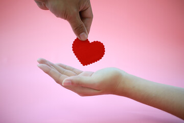Female hands giving red heart background.sharing love for everyone,Valentine's Day concept