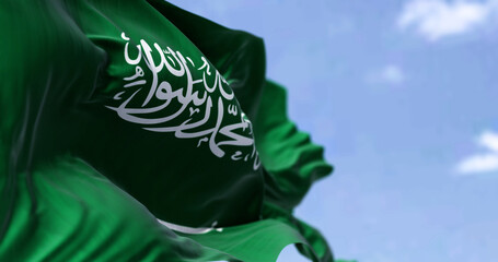 Detailed close up of the national flag of Saudi Arabia waving in the wind on a clear day