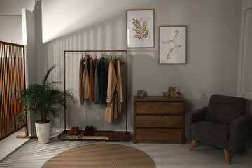 Modern dressing room interior with stylish clothes, shoes and decorative elements