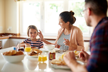 Having fun at the breakfast table. Shot of a family having breakfast together.