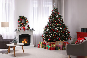 Beautiful Christmas tree and gifts near fireplace in festively decorated living room