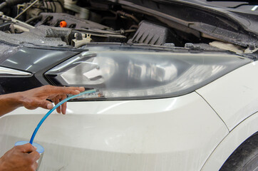 headlights are lacquered to give a shiny finish after the headlights are polished. car details