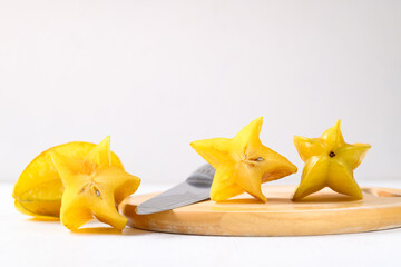 Sliced ripe star fruit or Carambola on cutting wooden board with white background, Tropical fruit