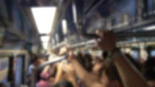 Blurred defocused asian people wearing protective mask against transmissible infectious diseases in subway entrance escalator leading into train station. Coronavirus protection