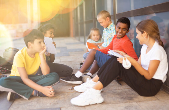 Portrait Of Primary School Girls And Boys Talking Outside Before Lesson And Having Fun