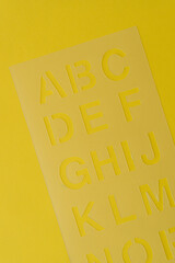 plastic stencil on yellow paper