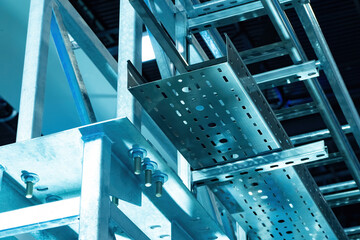 Metal cable tray close up. Metal frames for wiring and equipment. Cable trays at the enterprise. Cable-carrying systems made of steel. Metal perforated tray for laying cable routes