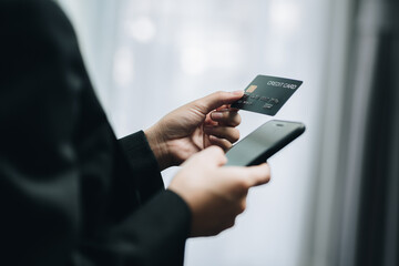 Businesswoman using a smartphone to payment shopping online via credit card. online shopping, e-commerce, internet banking, spending money.