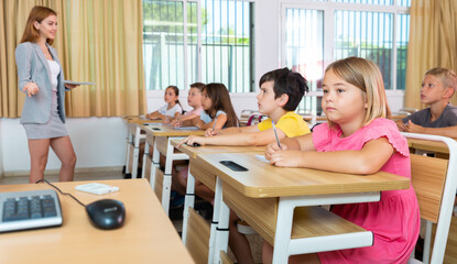 Fototapeta na wymiar Schoolchildren listening carefully to teacher in classroom during lesson.