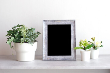 Blank grey vintage wooden frame on table and white wall banckground , banner, with copy space for mock up, template